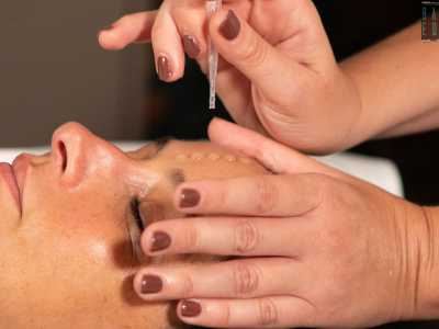 Infine versa un estratto di erbe pugliesi sulla fronte della ragazza per poi massaggiarle delicatamente il volto: un�azione che conclude il trattamento rilassante, idratante e purificante